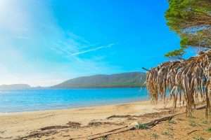 A view from the beach at Spiaggia di Mugoni on a summer's day, near Alghero, northwest Sardinia, Italy.