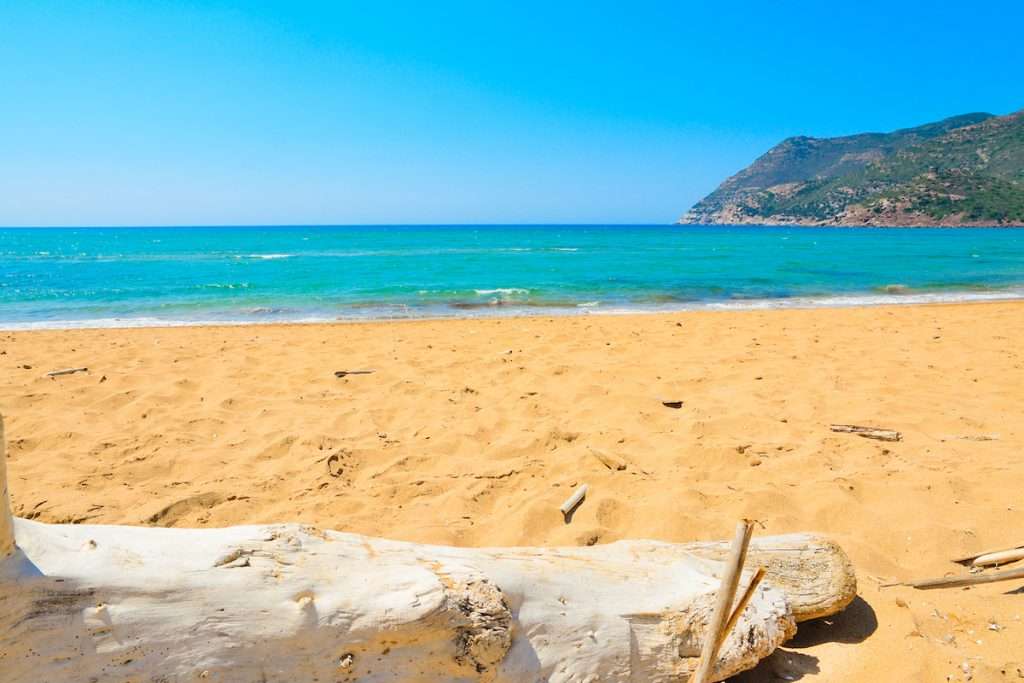 A view from the golden beach at Spiaggia di Porto Ferro, near Alghero, northwest Sardinia, Italy.